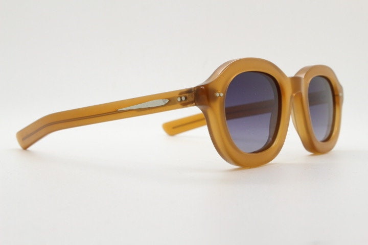Kopajos thick framed round sunglasses. Hand made transparent amber acetate chunky frame with contrasting graduating lenses