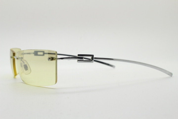Y2K vintage rectangular sunglasses. Minimal frameless light tone curved mirrored lenses with silver chrome trim. 2000's. 90s. 00s. NOS