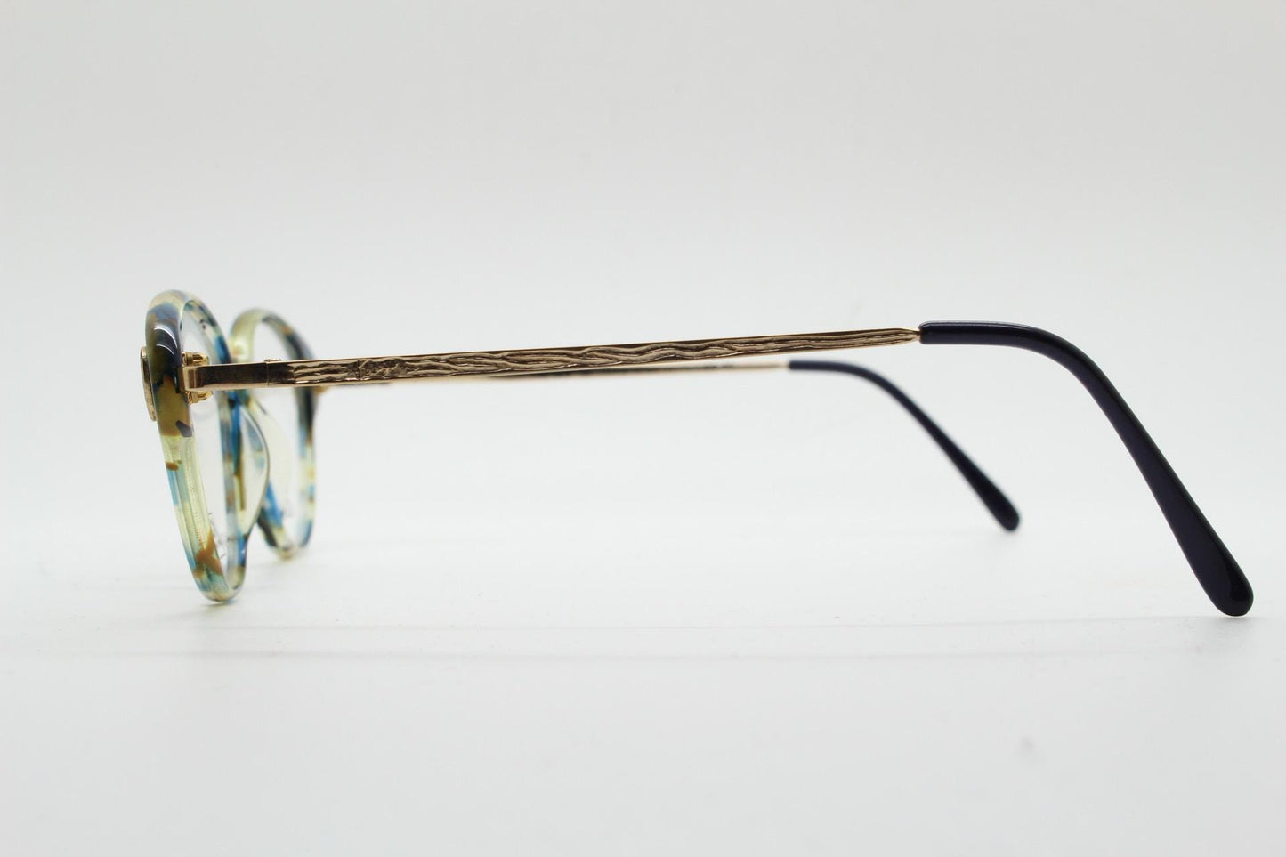 Kenzo 90s vintage cat eye glasses hand made in France. Transparent patterned optical frame with ornate arm details. Womens Prescription. NOS