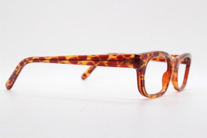 90s vintage rectangular low profile eye glasses. Transparent optical frame with vibrant amber giraffe pattern. Prescription eyeglasses. RX