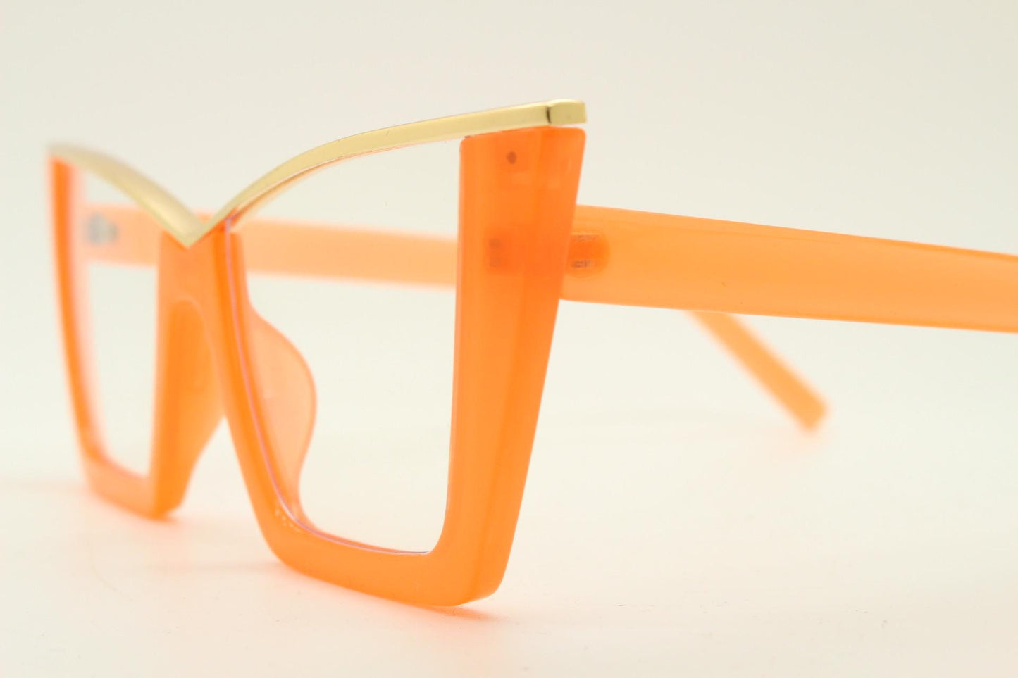 Dynamic pointed cat eye glasses. Transparent thick orange optical frame with gold metal 'owl' brow. and clear lenses. Vintage. Prescription