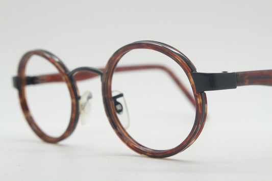 90s vintage oval glasses. Minimal slim black optical frame encasing tortoise inserts. 40s, 50s style prescription eyeglasses. RX spectacles