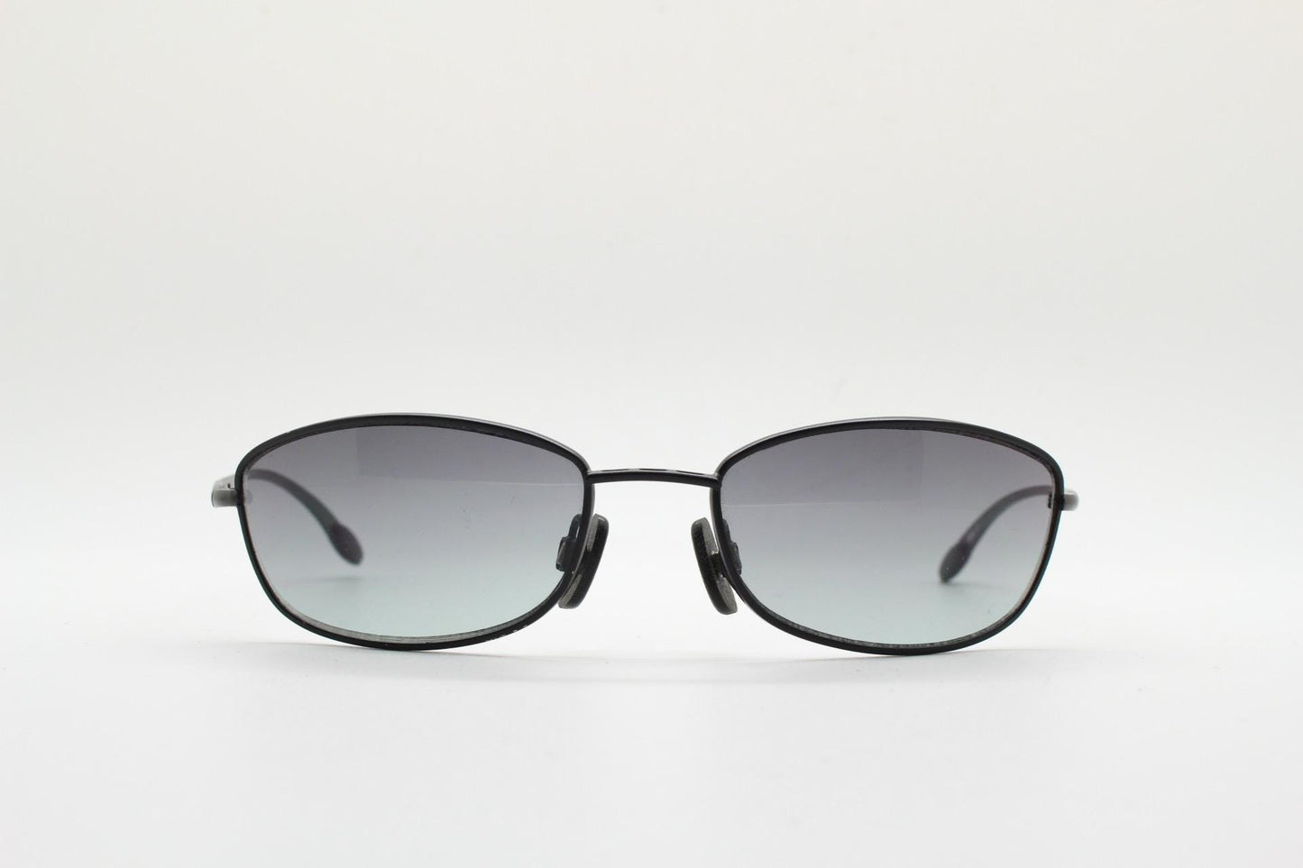 90s vintage curved rectangular sunglasses. Solid metal low profile black matt finish frame with slightly graduating lenses. 2000's. Y2K. NOS