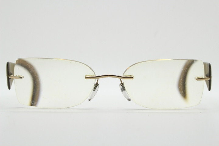 Silhouette rectangular frameless eye glasses model 7599 made in Austria. Minimal optical frame with transparent brown arms. Prescription RX