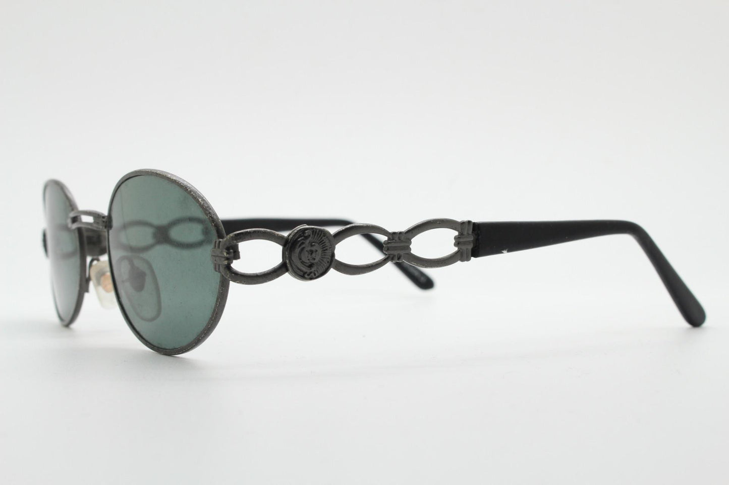 90s vintage low profile oval sunglasses. Authentic Gunmetal grey satin finish frame with chain link arm circles and real glass lenses. NOS