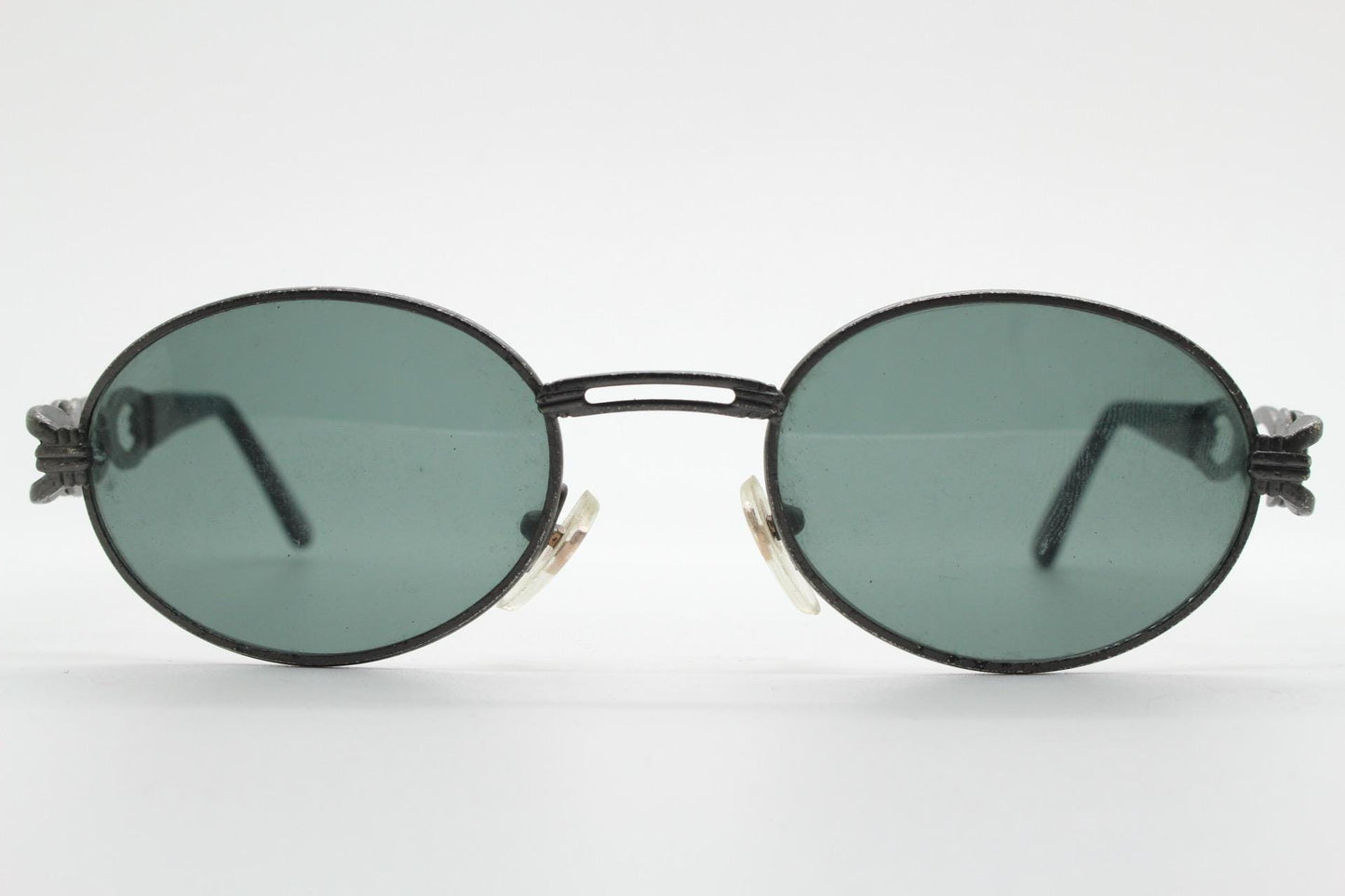 90s vintage low profile oval sunglasses. Authentic Gunmetal grey satin finish frame with chain link arm circles and real glass lenses. NOS