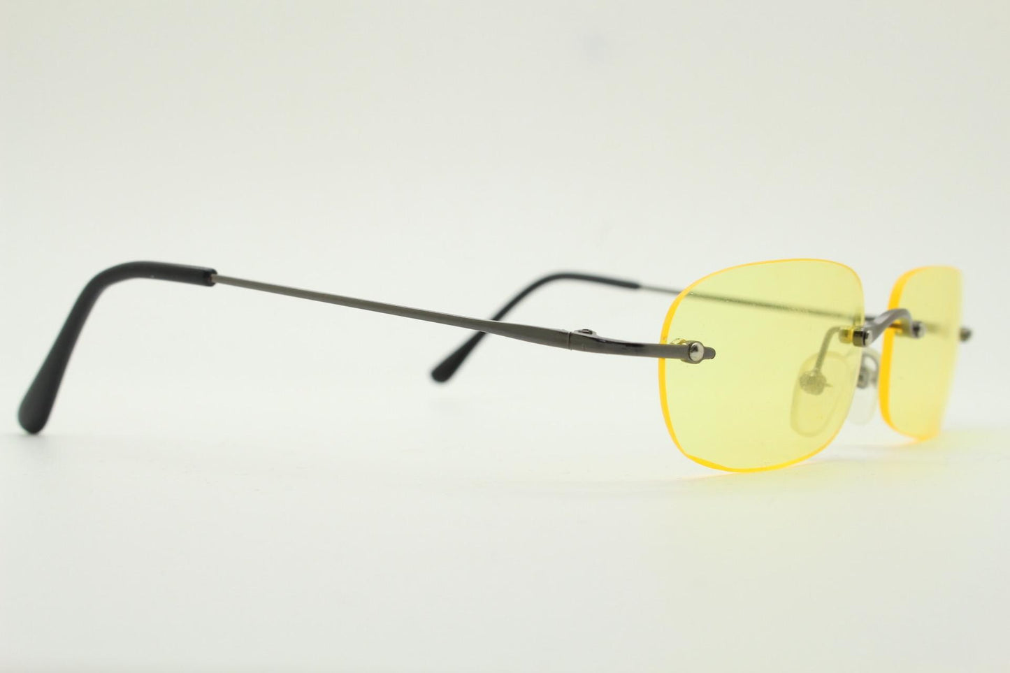 Y2K vintage frameless yellow sunglasses. Rectangular lenses with grey metal bridge and arms. 2000s club kids. 00's. 90s Rave