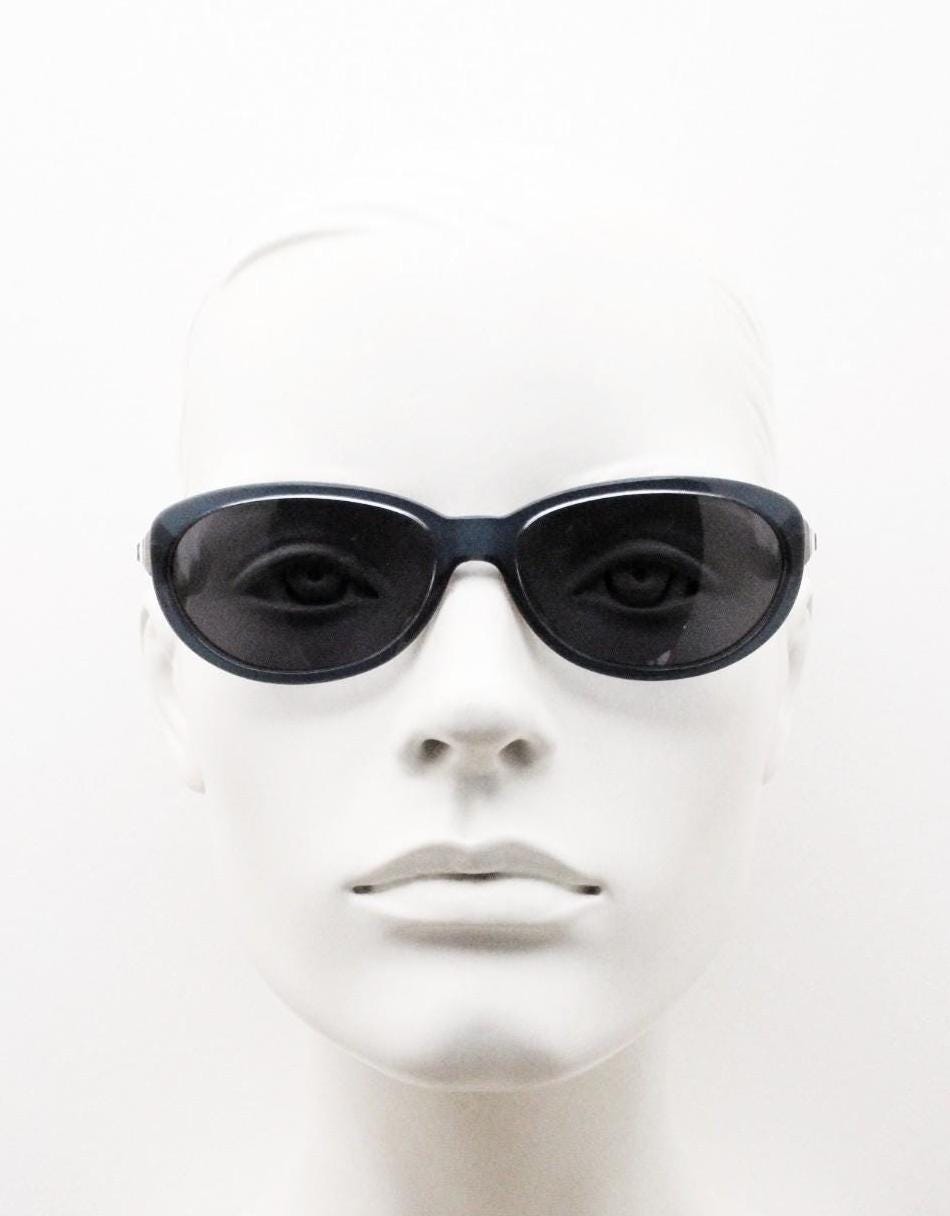 Genny 90s vintage oval cat eye sunglasses made in Italy. Transparent deep blue acetate frame with matching lenses. Womens NOS cateye. BNWT