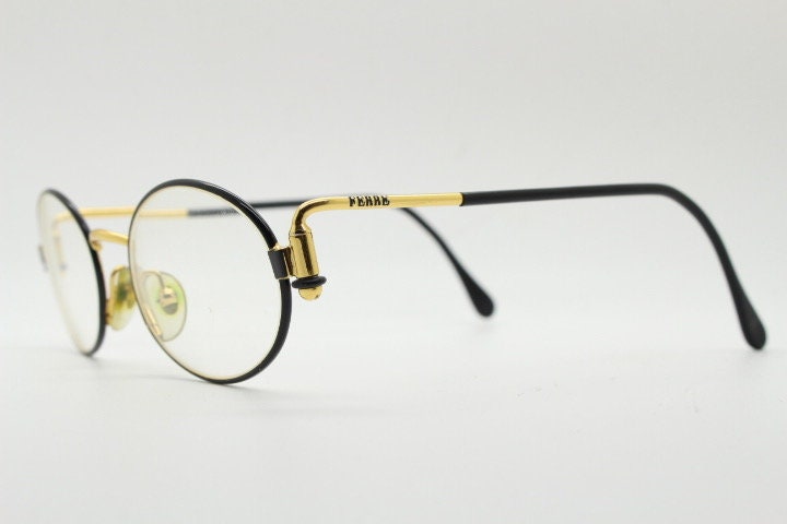 Gianfranco Ferre 90s vintage oval eye glasses made in Italy. Black and gold metal tech design optical frame. Prescription RX. NOS