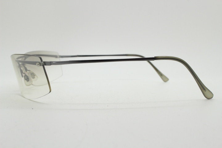 Y2K vintage wraparound sunglasses. Sick fashion grail half frame in grey chrome with extra light tone curving mirrored lenses. 2000's NOS