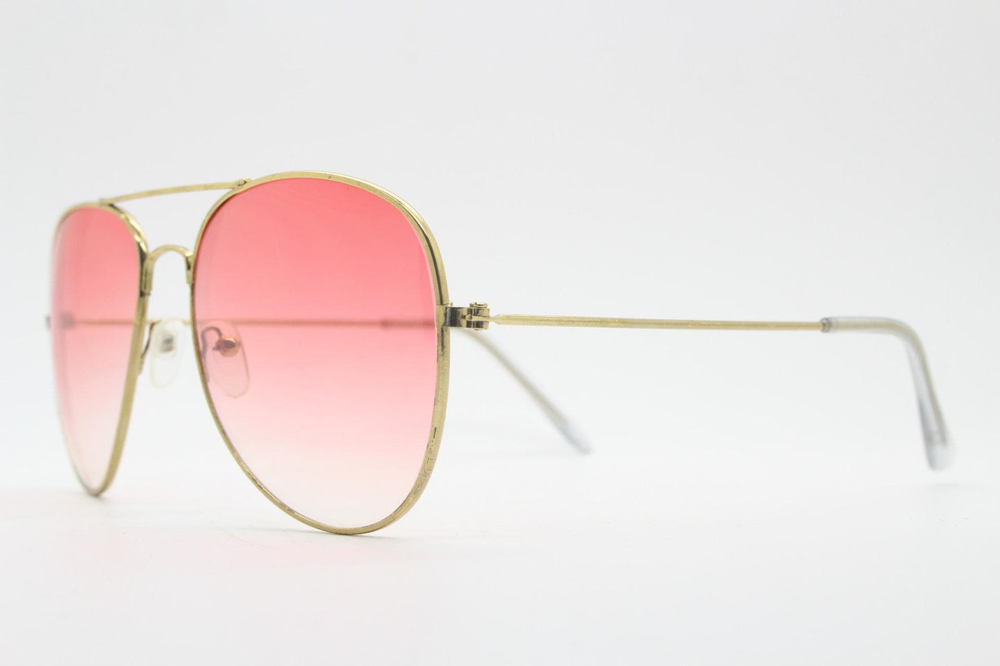 Y2K vintage aviator sunglasses. Gold metal frame pilot aviators with atmospheric light pink gradient lenses. Teardrop. 70s. 2000s. 00s NOS