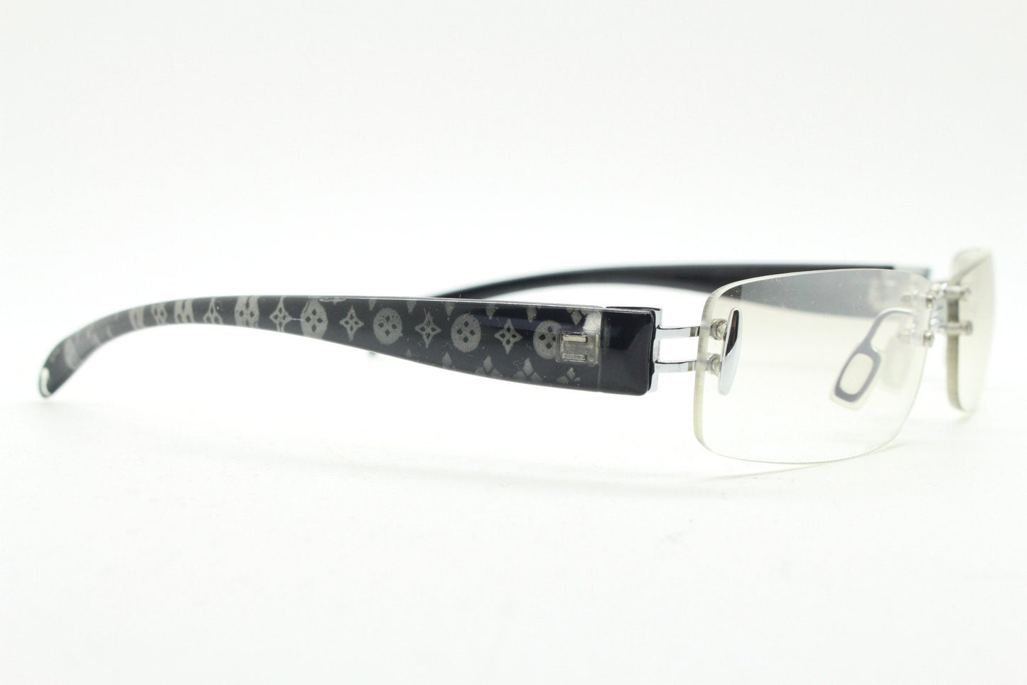 Y2K vintage frameless sunglasses. Silver chrome trim with patterned arms and extra light tone graduated curved mirror lenses. 2000's. 90s