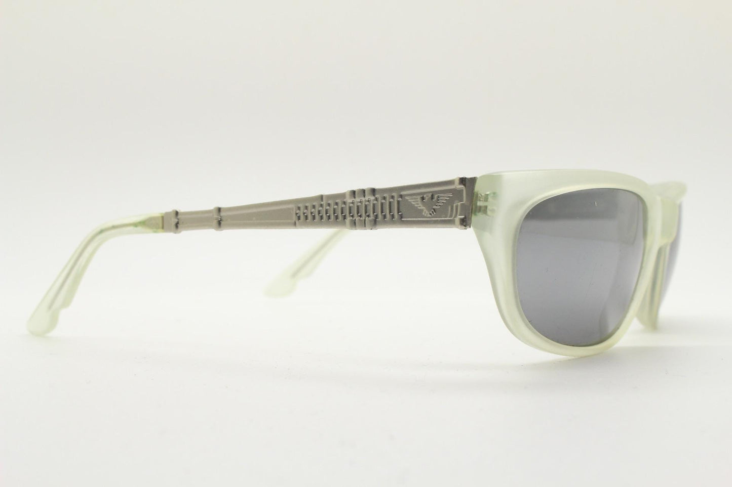Dakota Smith vintage 90s futuristic sunglasses. Transparent frosted wrap around shield frame with mirror lenses and ornate arm patterns