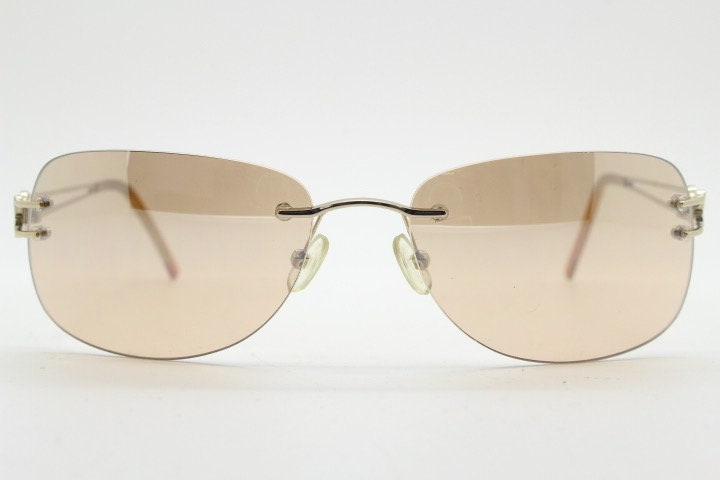 Y2K vintage rimless rectangular sunglasses. Frameless 2000's brown lens with slight mirror glaze gold trim and butterfly hinges. 00's NOS