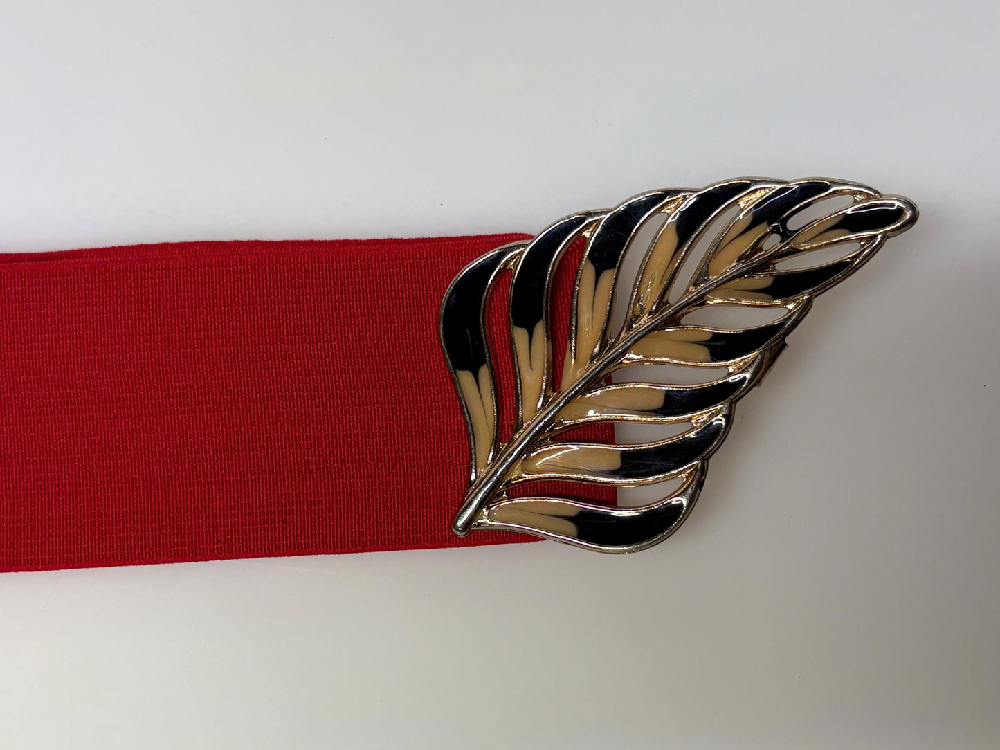 80s vintage womens elastic tall belt. Large exotic palm leaf buckle. Flattering cinch effect. Extensive adjustable size range. Unused NOS