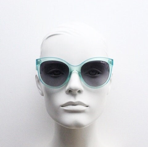 Pepe Jeans big cat eye sunglasses. Transparent chunky aquamarine frame with contrasting black graduating lenses. Womens vintage cateye