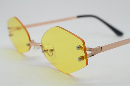 Y2K vintage frameless hexagon sunglasses. Bright yellow lenses with rose gold bridge and arms. 2000s, 00's. 90s