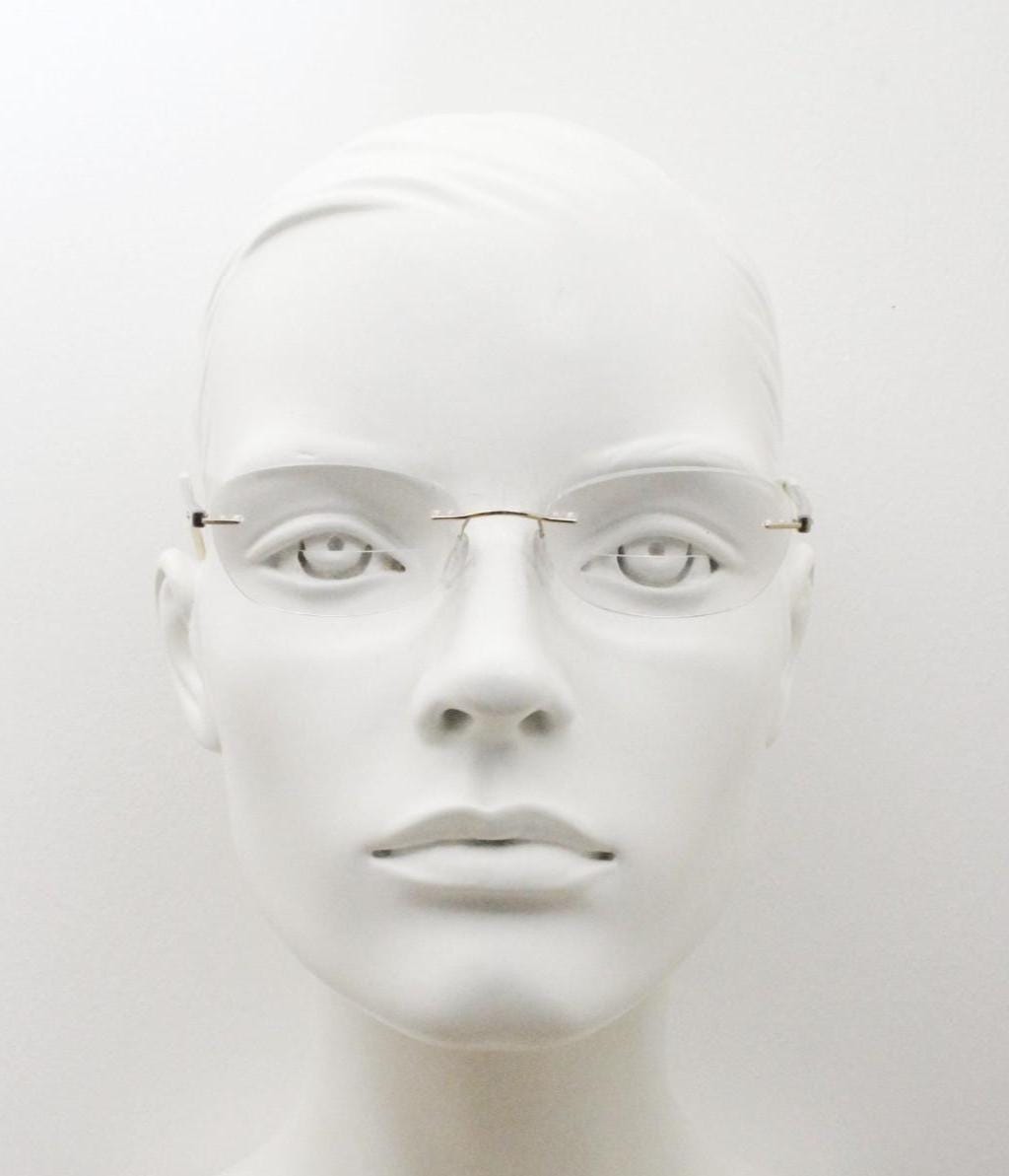Silhouette rectangular frameless eye glasses made in Austria. Minimal lightweight gold with white enamel frame. 90s vintage. Prescription RX