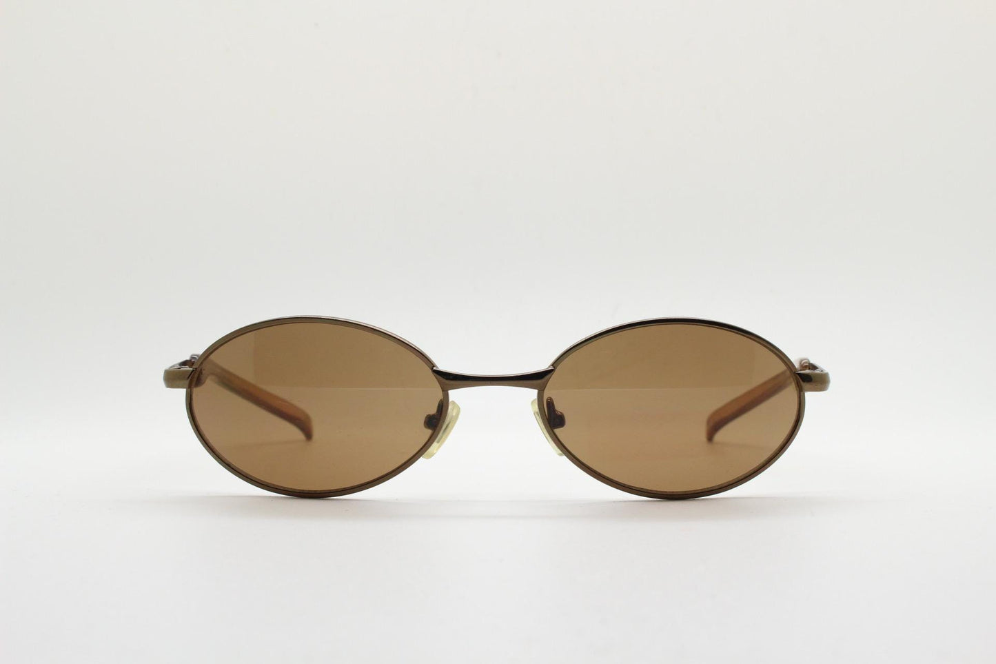 90s vintage small oval bug eye sunglasses. Minimal brown chrome finish metal frame with transparent curved arms. Y2K. Unused NOS