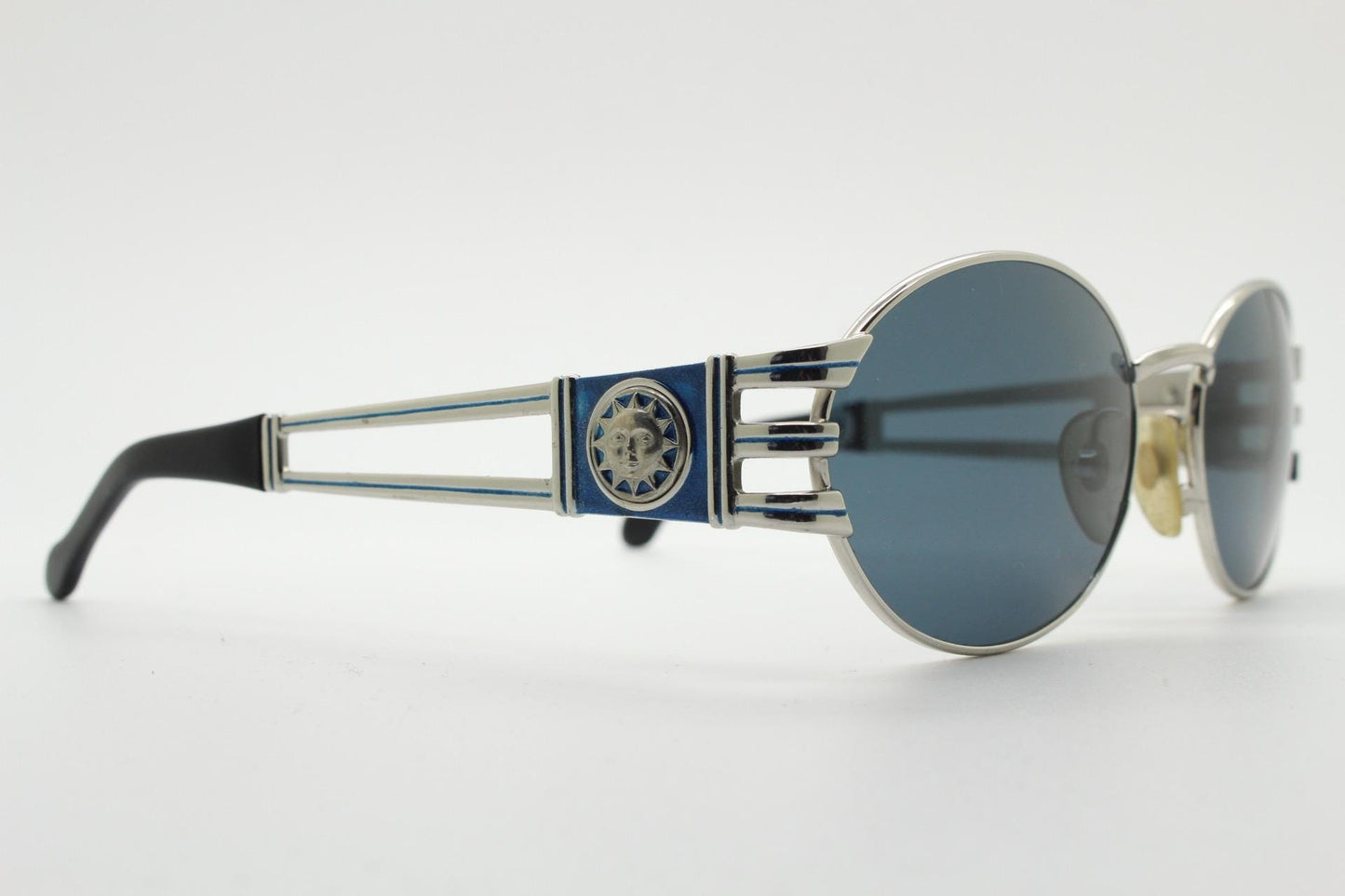 Sunsweet 90s vintage metal oval sunglasses made in Italy. Definitive ornate temple design with classical sun crests in silver chrome. NOS