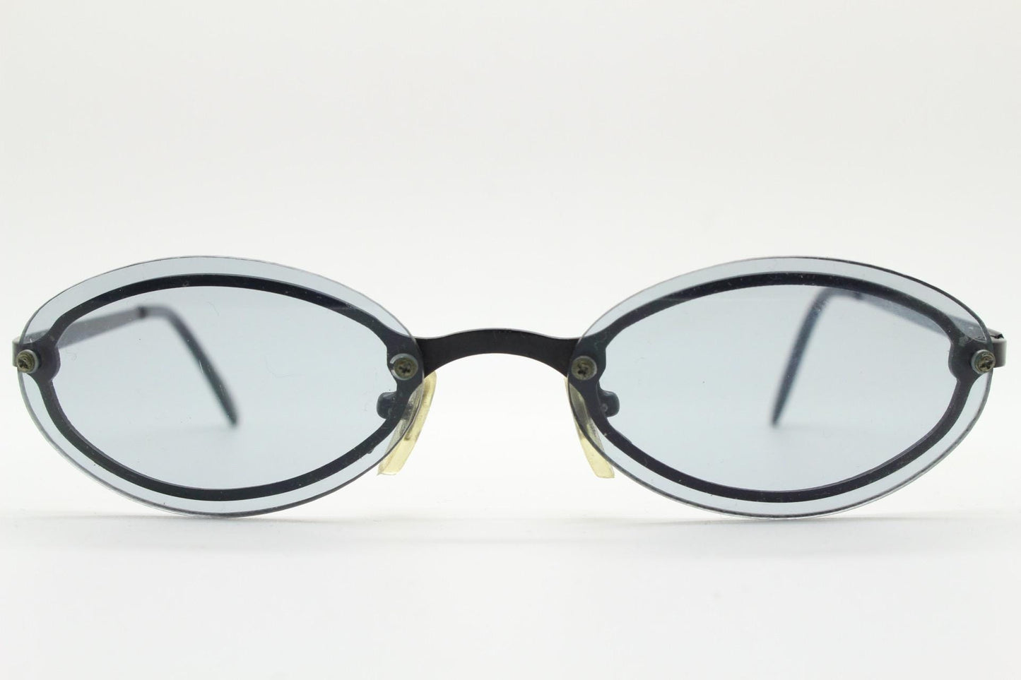 90s vintage small oval sunglasses. Minimal black metal frame with clever overlapping lens design in light tone grey. Micro. Steampunk. NOS