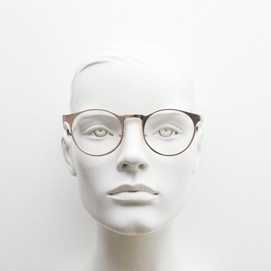 Y2K round metal eye glasses with pointed corners. Solid flat shiny golden frame with clear lenses.