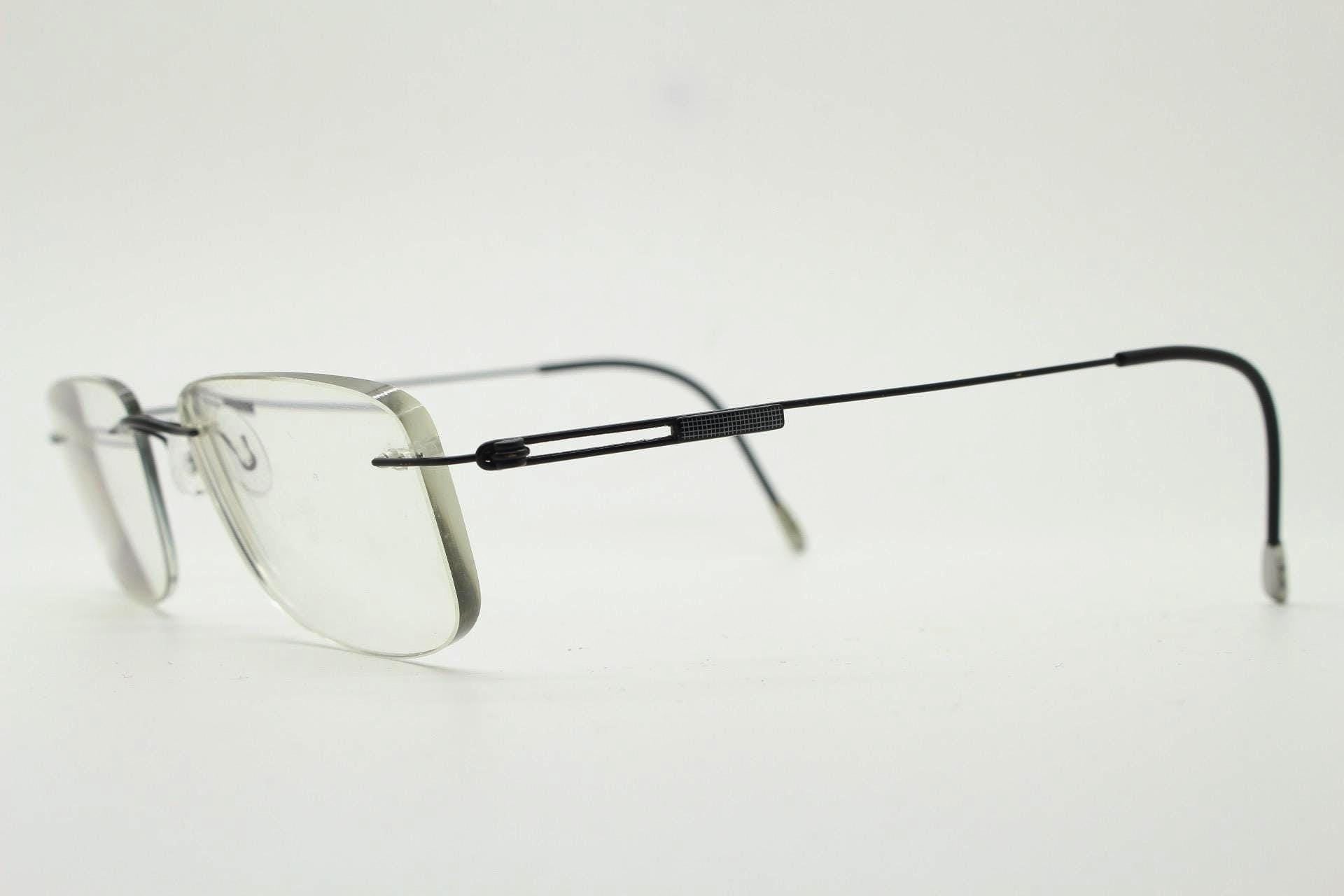 A pair of rimless, wire-rimmed glasses with a sleek, modern design.