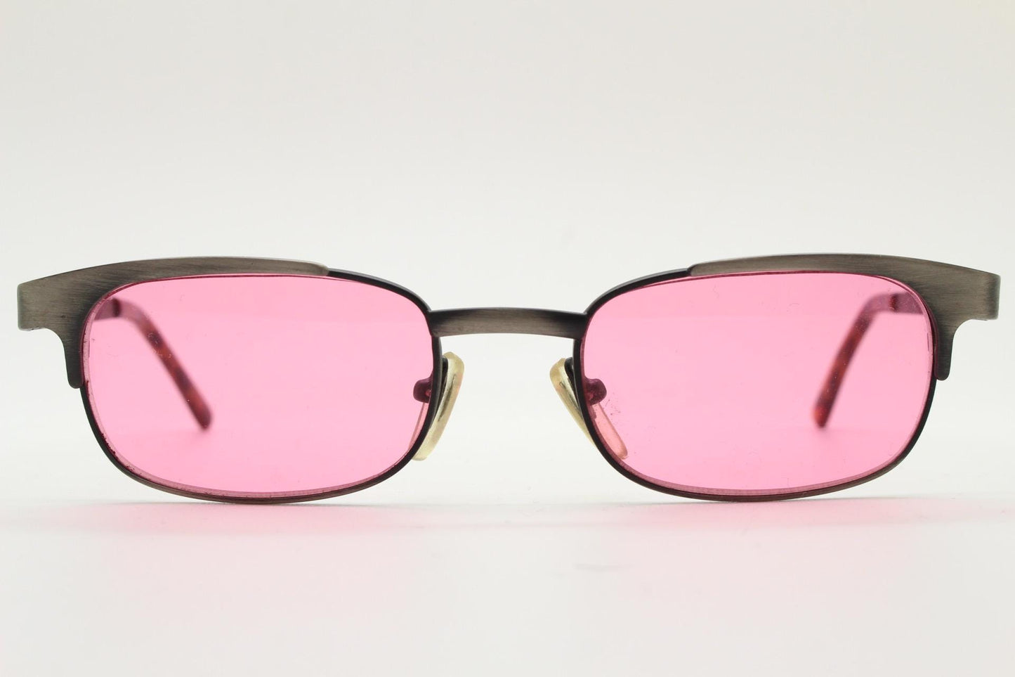 90s vintage rectangular sunglasses with bright pink lenses. Solid metal low profile frame in a brushed bronze finish. Y2K. NOS