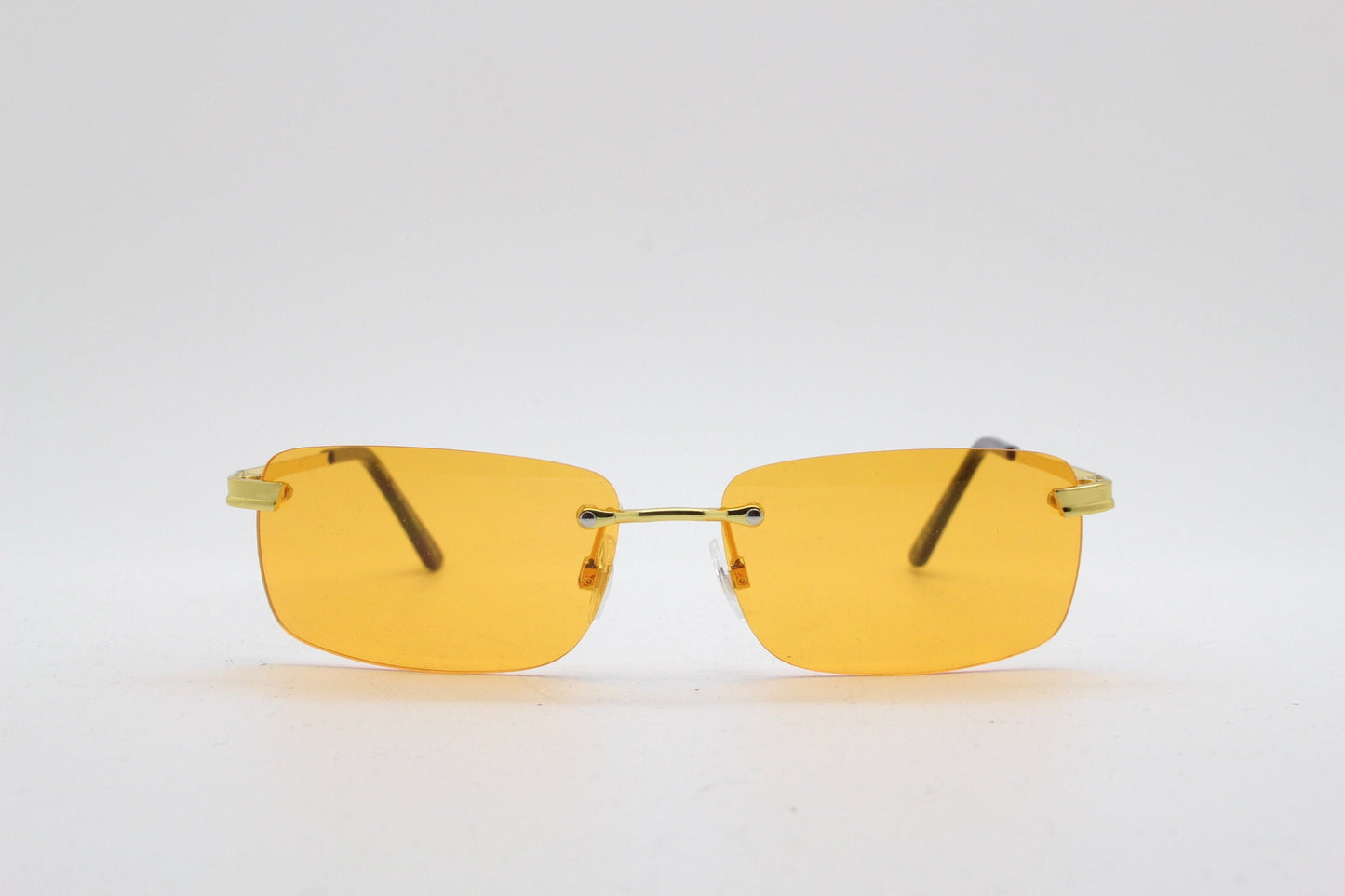 Y2K vintage frameless orange sunglasses. Rectangular lenses with gold bridge and arms. 2000s club kids. 00's. 90s Rave