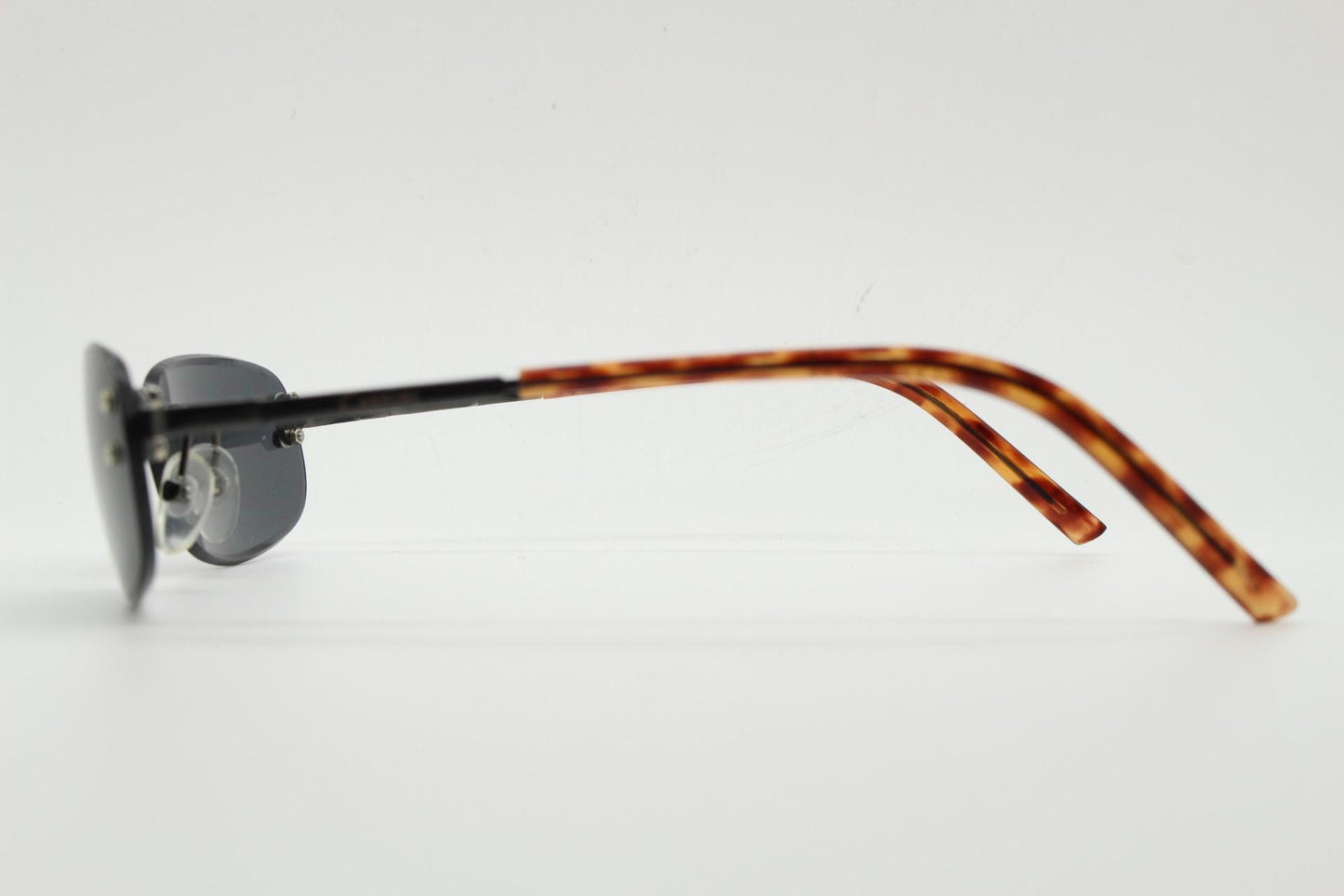 90s vintage minimal frameless sunglasses. Black rectangular lens with gunmetal grey trim and tortoise arms. Simple and effective design. NOS