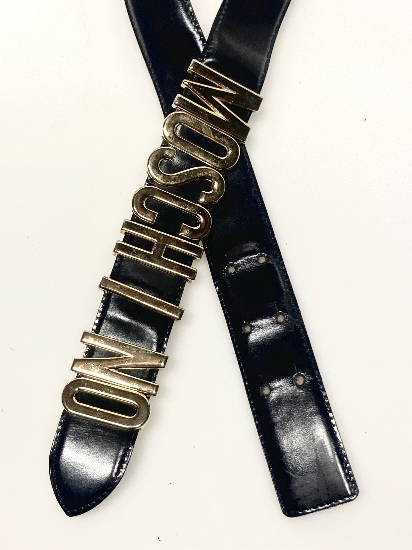 Moschino 90s vintage womens dress belt in black genuine leather. Iconic individual golden moving letters logo. Made in Italy. 80s. NOS