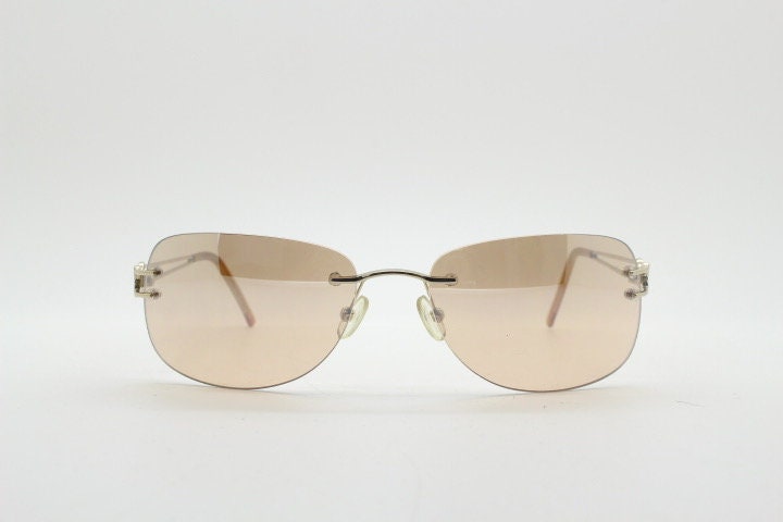 Y2K vintage rimless rectangular sunglasses. Frameless 2000's brown lens with slight mirror glaze gold trim and butterfly hinges. 00's NOS