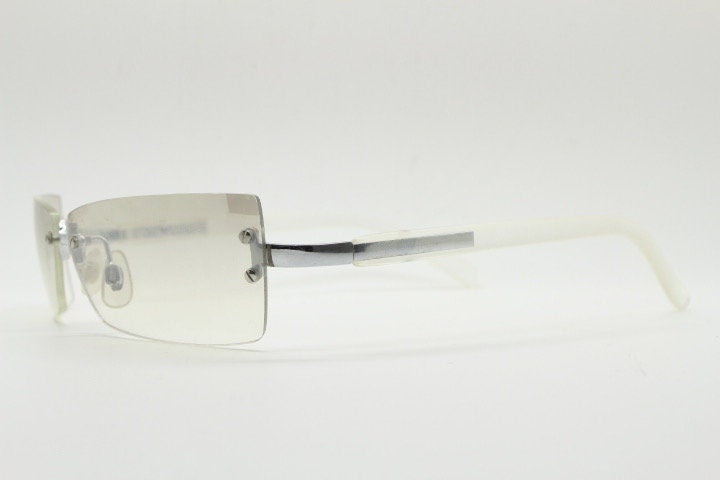 Y2K vintage  frameless sunglasses. Minimal light tone curved mirrored lenses with white frosted arms. 2000's. 90s. 00s. NOS