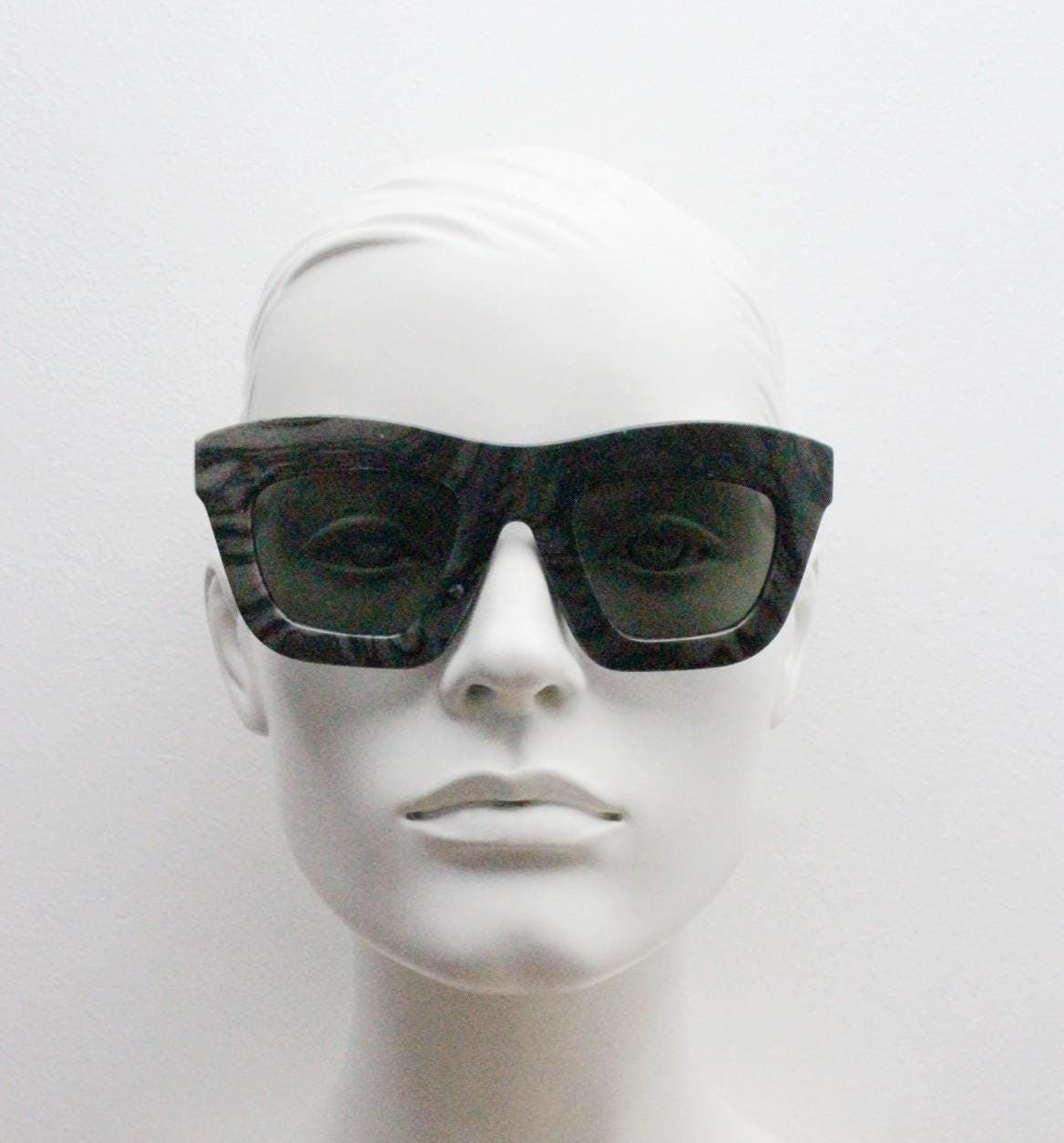 Cheap Monday thick frame cateye sunglasses. Womens chunky oversized grey and black marble cat eye with dark green lenses. Y2k vintage