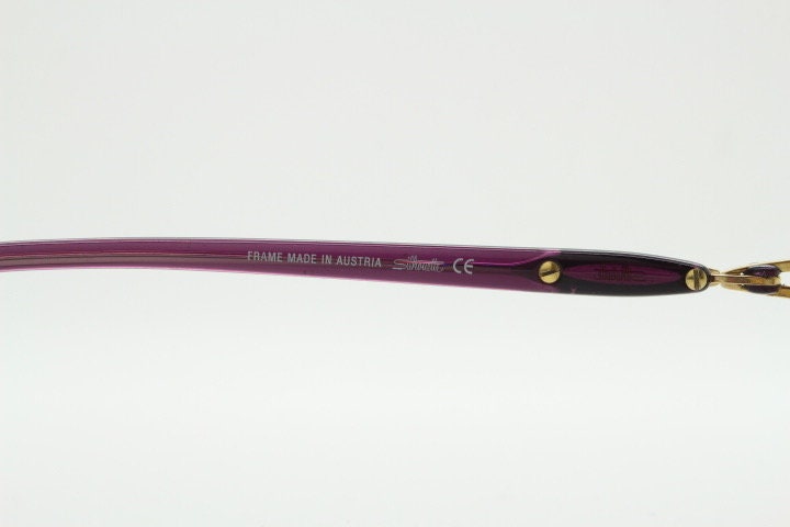 Silhouette oval half frame eye glasses model 6566 made in Austria. Minimal optical frame with gold trim deep purple arms. Prescription RX