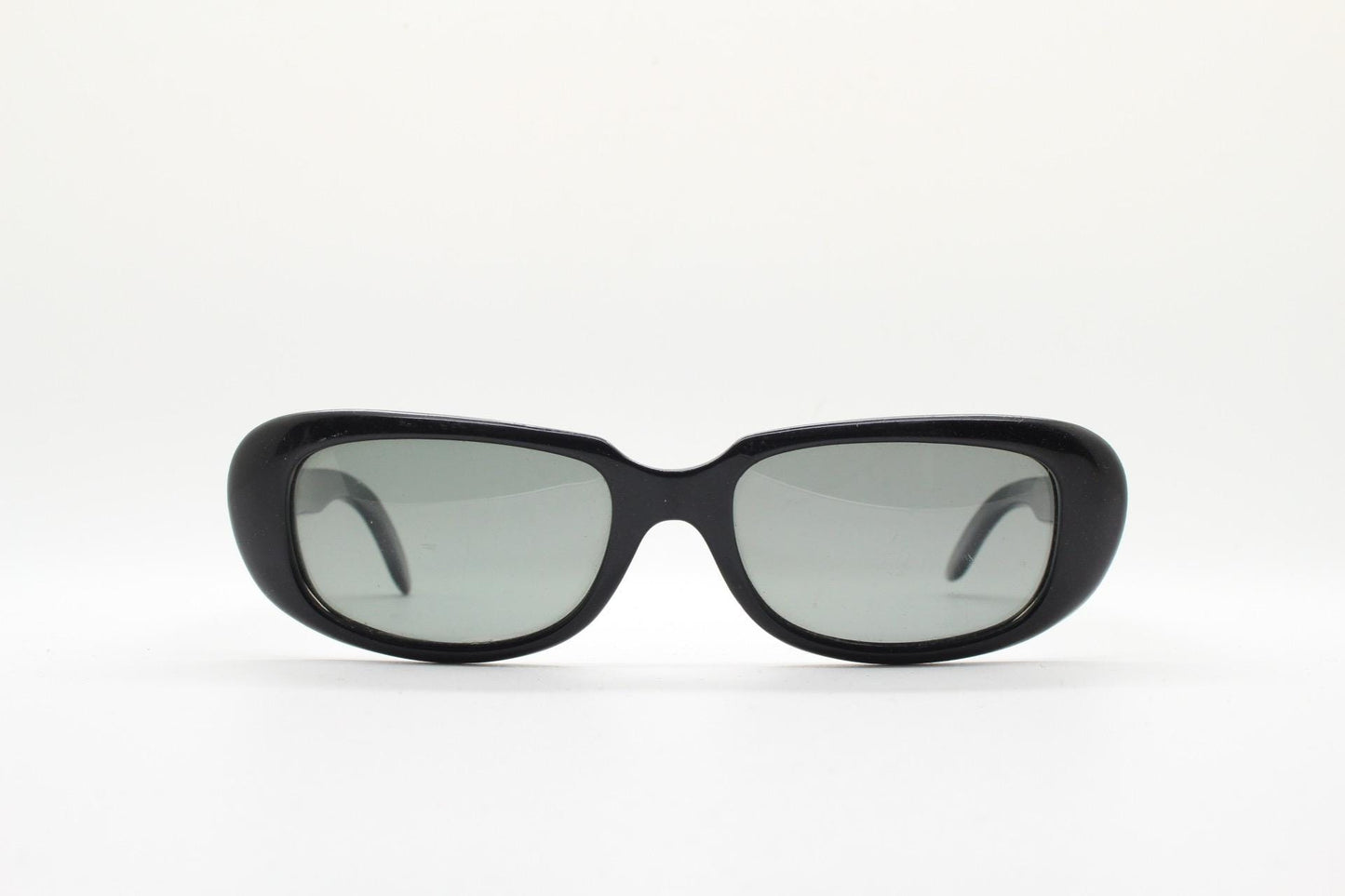 Polaroid 60s vintage rectangular sunglasses made in England. Authentic plain black frame with atmospheric curved lenses. Mens mod