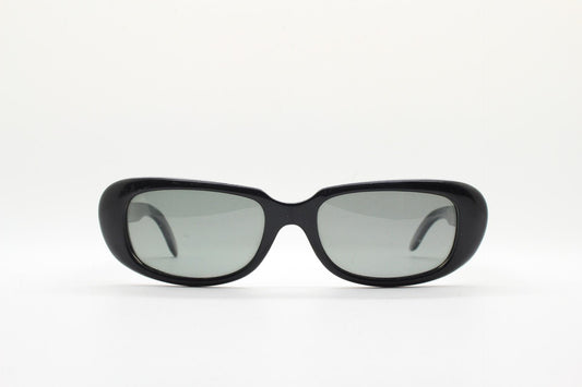 Polaroid 60s vintage rectangular sunglasses made in England. Authentic plain black frame with atmospheric curved lenses. Mens mod