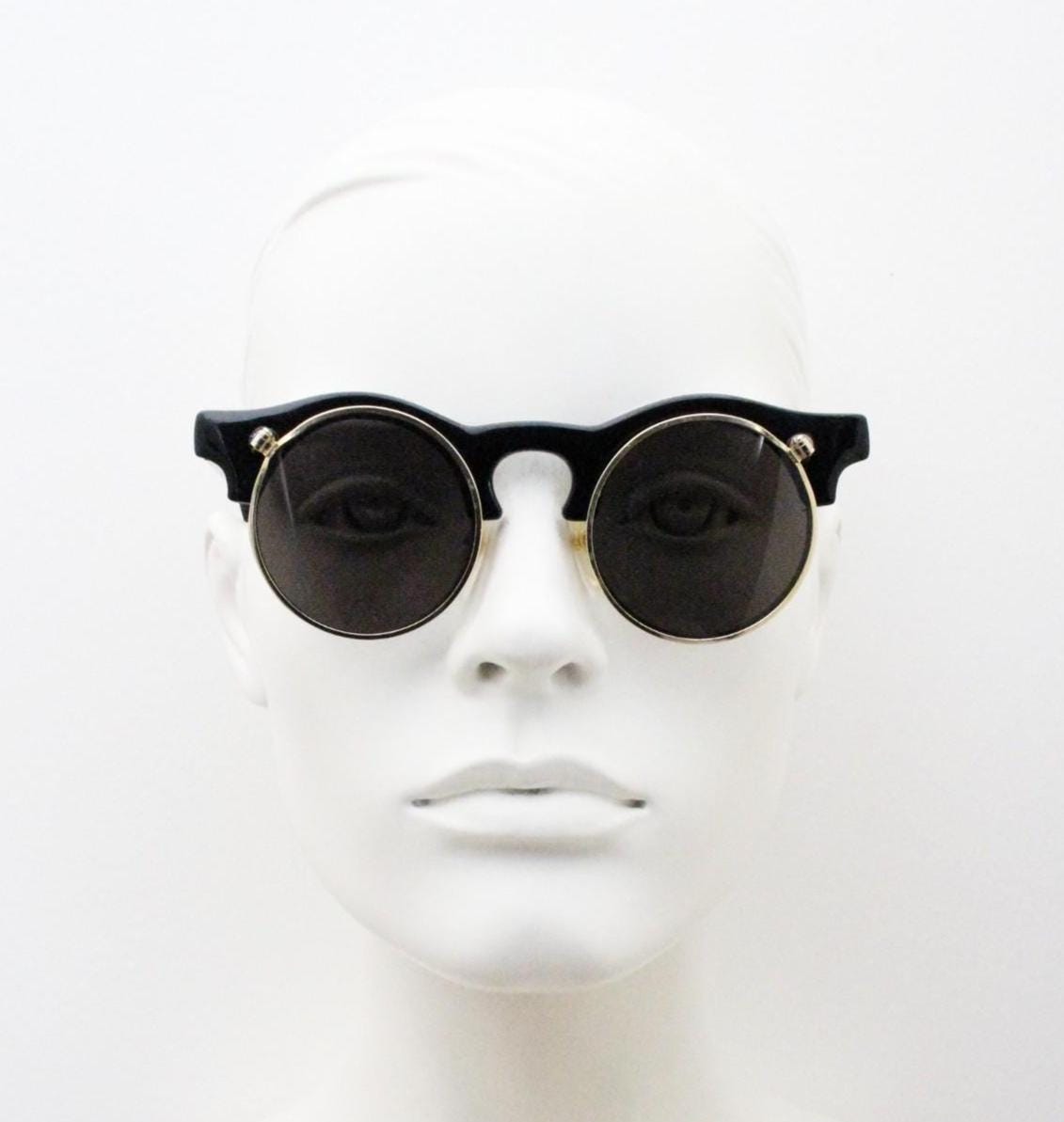 Vintage 80s round flipper sunglasses. Black gloss frame with clear lenses and incredible side flip up shades . BNWT unused NOS