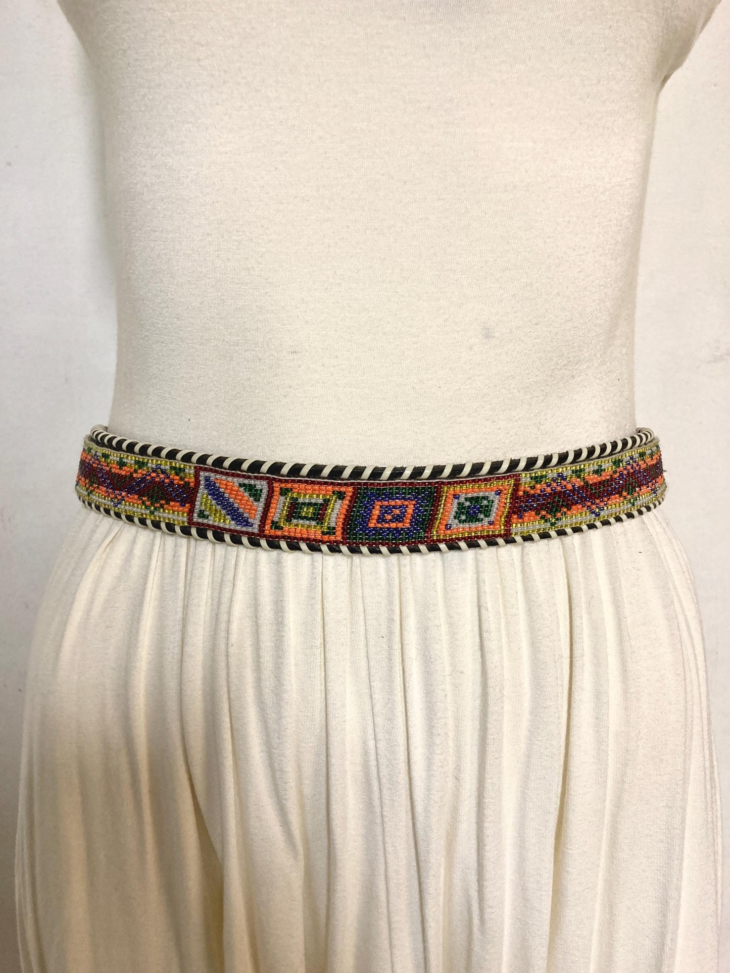 80s vintage thick Leather Native American Indian style belt. Full beaded applique, looped tape edge, embossed pattern and textured buckle