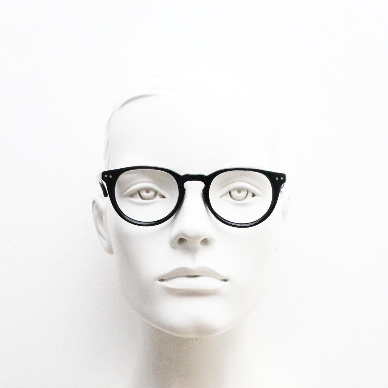 90s vintage oval eye glasses by Alles Brille of Germany. Classical black gloss acetate optical frames with keyhole bridge. RX Spectacles