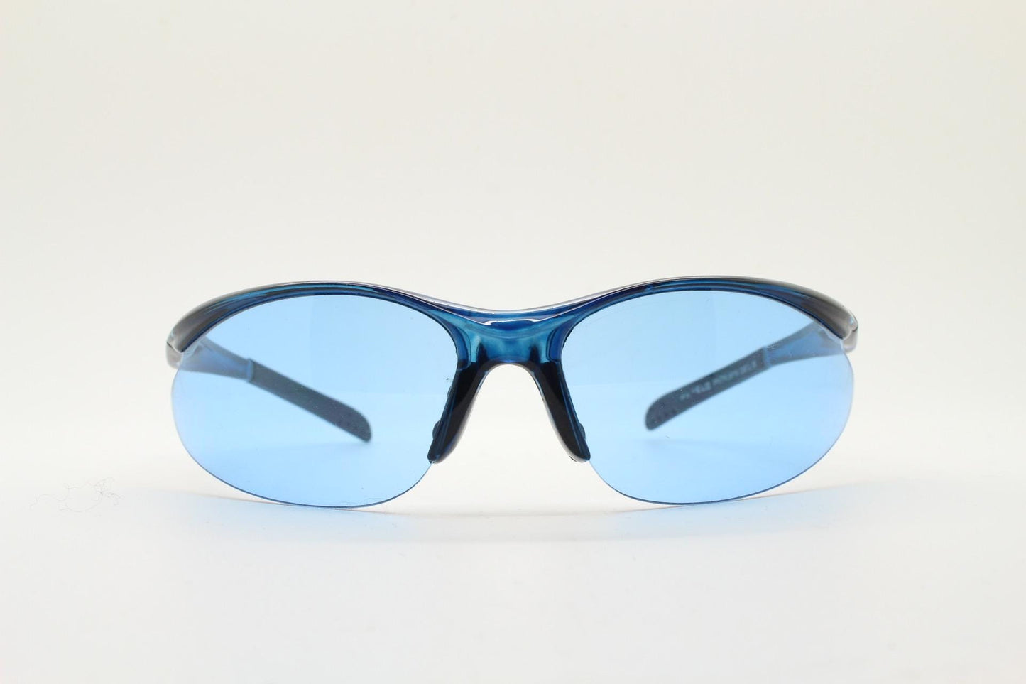 Y2K vintage sport shield sunglasses. Transparent blue frame wraparound aerodynamic visor with matching lenses. 2000's. 90s
