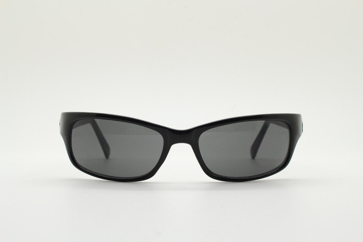 90s vintage curved wraparound sunglasses. Aerodynamic low profile plain black gloss curved cat eye frame. Minimal shield design. NOS