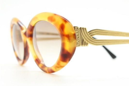 Lanvin 90s vintage chunky oval sunglasses made in France. Mottled honey brown acetate 60s design with detailed arms and light tone lenses