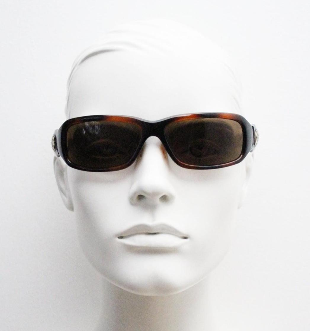 Y2K vintage curved wraparound sunglasses by Animal. Aerodynamic mottled brown gloss curved frame. Shield bug eye design. Biker shades. NOS