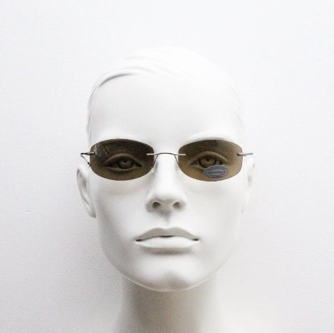 Faconnable 90s vintage sunglasses model 859 hand made in Italy. Minimal frameless design with flexible wire arms and brown chrome trim. NOS