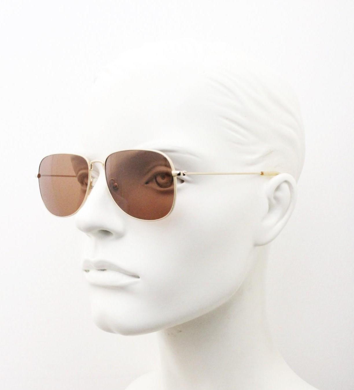 Helmut Lang rectangular 90s vintage sunglasses made in Japan. Minimal gold chrome frame with warm brown lenses. Luxury modified aviator