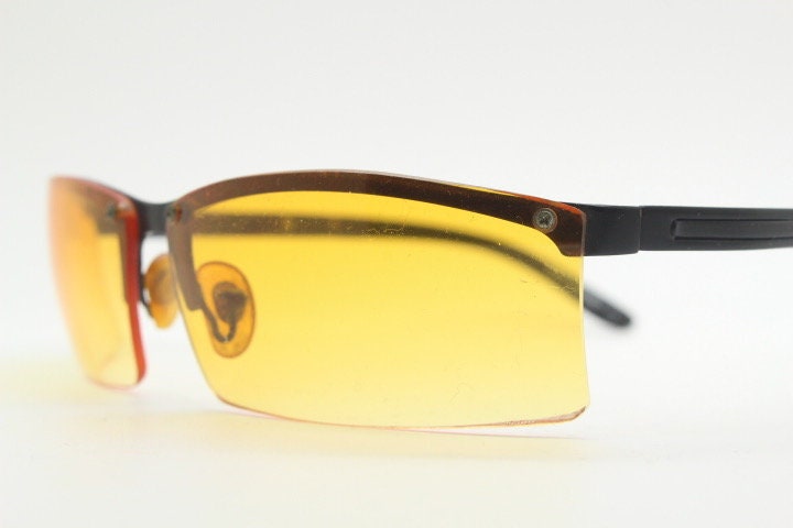 Y2K vintage half frame visor sunglasses. 2000's black brow line with light tone blazing orange rectangular curved lenses. 00's
