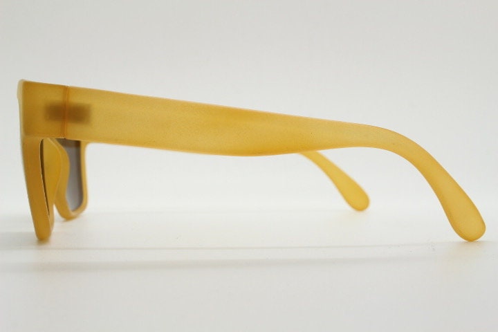 IDC lunettes modified wayfarer design sunglasses made in France. Transparent frosted yellow acetate chunky frame with contrasting lenses
