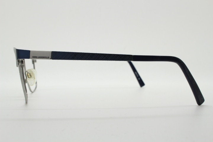 Karl Lagerfeld squared wayfarer shape eye glasses. Navy check pattern arms with satin finish brow optical frames. Prescription eyeglasses.