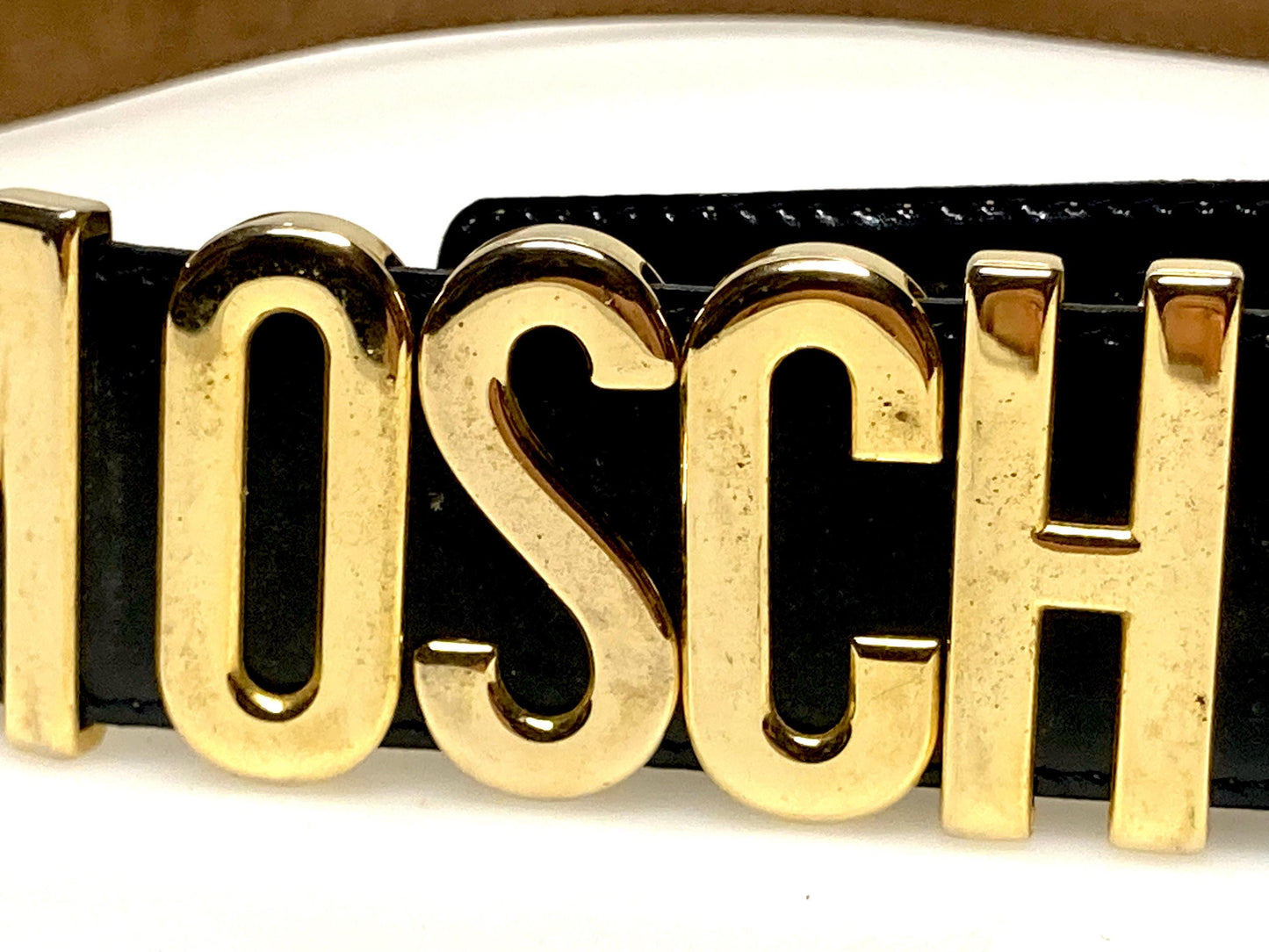 Moschino 90s vintage womens dress belt in black genuine leather. Iconic individual golden moving letters logo. Made in Italy. 80s. NOS